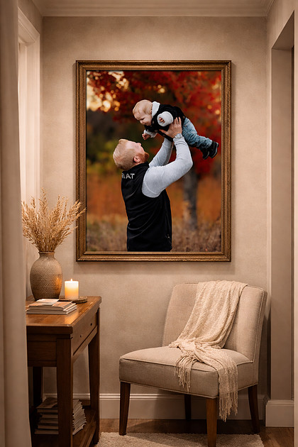 framed wall art portrait of father lifting baby during fall family photography session with autumn colors displayed as large framed print by Sioux Falls family photographer