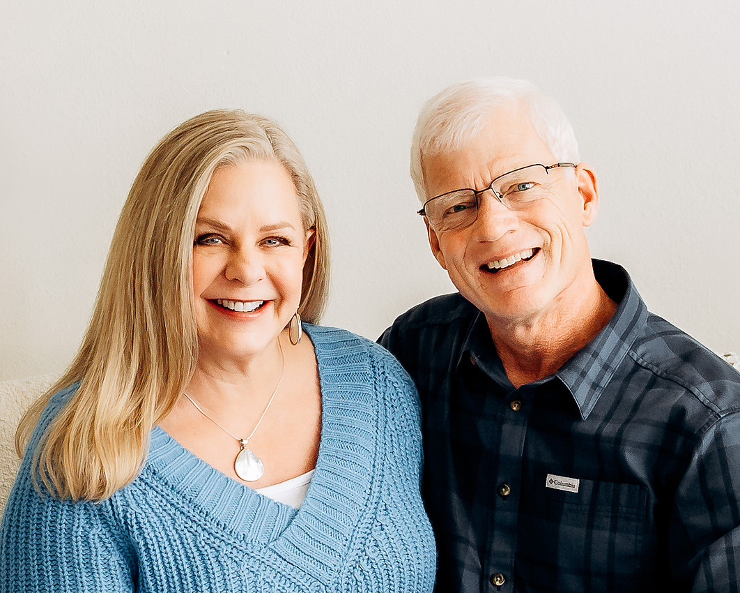 Older couple smiling at camera during professional family photo session in Sioux Falls